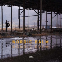 Nordic Balm cover, a silhouette of a saxophone player (Karl Seglem) in an industrial setting, outdoors, possibly in an old factory