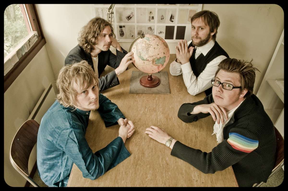 The band, shot from above. Four young men looking into the camera